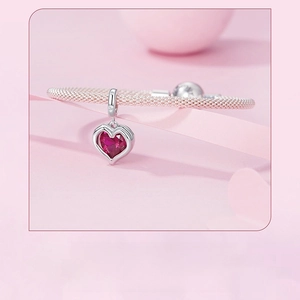 Macro detail of S925 sterling silver mesh chain bracelet with a heart red gemstone charm