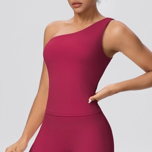 Detail of asymmetric one-shoulder sports bra in dark red with high-stretch fabric