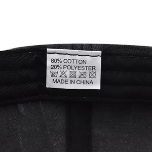 Detail shot of the wash care label showing 80% cotton 20% polyester blend fabric composition