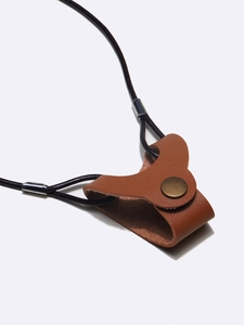 Close-up of brown leather eyeglass cord with bronze metal snap and silver hardware