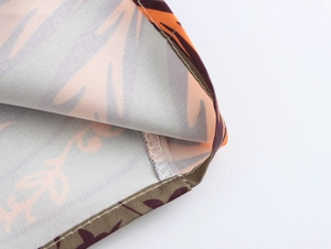 Detail shot of the floral fabric texture and high-quality stitching on the beach shirt set