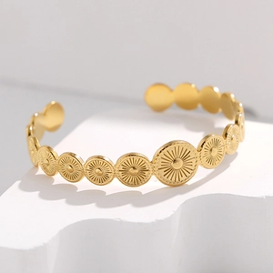 Retro geometric open cuff bracelet in gold finish with sunburst engraved circular discs
