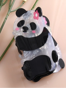 Detail of cute panda hair claw clip made from premium acetate with pink flower accents