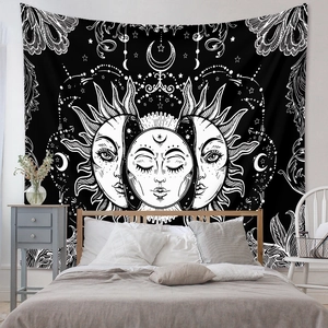 Detail of bohemian sun and moon tapestry hanging as bedroom decor with cosmic patterns
