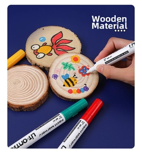 Macro shot of waterproof oil-based paint marker used on a wooden surface for DIY