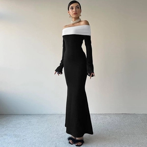 Detail view of a slim-fit off-shoulder dress with black and white color-block fishtail hem