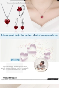 Three-piece jewelry set with red heart-shaped gemstones including necklace, earrings and ring
