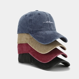 Stacked vintage washed cotton baseball caps in blue, khaki, burgundy and black colors