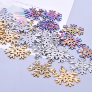 Macro shot of colorful snowflake charms in gold silver and rainbow for DIY jewelry