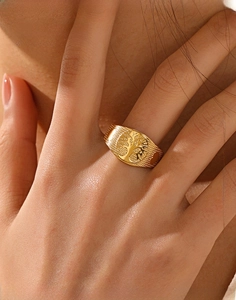 Macro shot of 18k gold plated Tree of Life ring with unique mesh texture band on hand