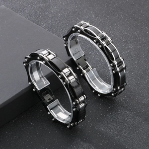 Detail of mixed-color steel bike bracelet showing carbon fiber inlays and chain link texture