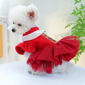 Detail of red pet wedding dress with white pleated collar and embroidery on a Bichon