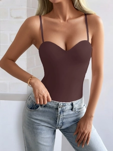 Detail of brown Y2K halter neck bodysuit top styled with light blue denim jeans