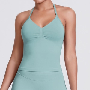 Detail view of mint green seamless ribbed yoga vest with ruched V-neck and halter straps