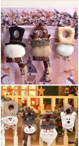 Detailed view of handmade Christmas plush door hangers featuring Santa and reindeer dolls