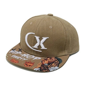 Close-up of khaki flat-brim hip-hop hat with embroidery and graphic printed brim