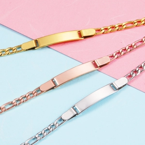 Detailed macro view of three personalized Figaro chain bracelets in gold, silver, and rose gold