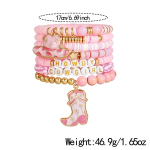 Detail of pink and gold clay bead bracelet set with Howdy Cowgirl engraved charms