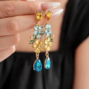 Vintage floral drop earrings with colorful crystals and blue teardrop pendant in gold finish