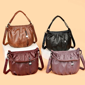 Ruched vintage tote bags in brown, black, burgundy, and purple on a pedestal