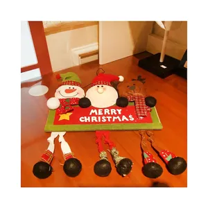 Christmas hanging sign with Santa, Snowman and Reindeer figurines on wooden background