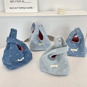 Detail of denim knot wrist bags featuring red gingham lining and various blue patterns