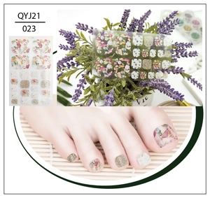 Macro detail of pink marble toe nail stickers with gold foil accents and glitter design