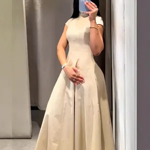Elegant beige mock neck short sleeve midi dress with a flowing A-line flared skirt