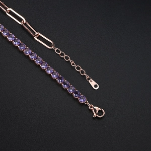 Close-up of paperclip chain and purple zircon tennis bracelet with lobster clasp