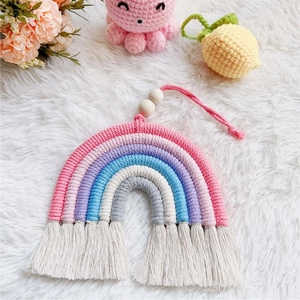 Detailed handmade woven rainbow wall decor with colorful cotton ropes and white tassels