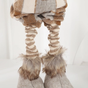 Detail of Christmas gnome plush with plaid fabric and soft faux fur trim boots