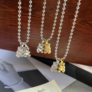 Detail of titanium steel ball chain necklace featuring smooth and zircon bear pendants