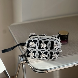 Artistic black canvas handbag with white embroidery and decorative tassels for women