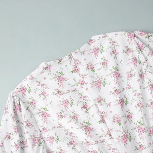 Detail of invisible back zipper and puff sleeve on pink floral print dress