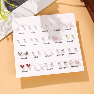 Set of 20 pairs of pearl earrings with heart, butterfly, and flower designs on a card