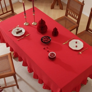 Close-up of red cotton linen tablecloth featuring decorative ruffled lotus edges