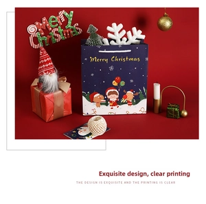 Detail of blue Christmas gift bag featuring cute cartoon illustrations and festive scenery