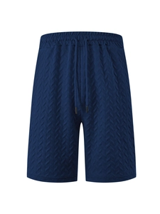 Detail showing dark blue jacquard fabric texture and drawstring on men's beach shorts
