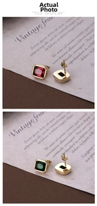 Close-up of square cut red and green zircon earrings with gold plated stainless steel
