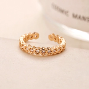 Adjustable gold ring with single row of cubic zirconia in a honeycomb hexagon design