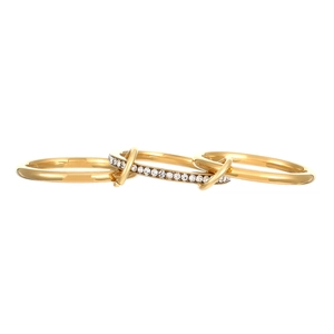Detail of three-in-one interlocking gold rings with pave-set crystals and polished bands