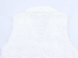 Close-up of white dress with textured wavy pattern and elegant turnover collar