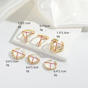 Elegant gold-tone adjustable ring set with clear cubic zirconia on a luxury marble surface