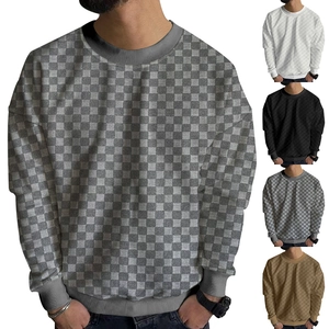 Detailed view of checkered knit sweaters showing gray, white, black and camel color options