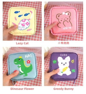 Detail view of four cute portable sanitary pad pouches in various cartoon patterns