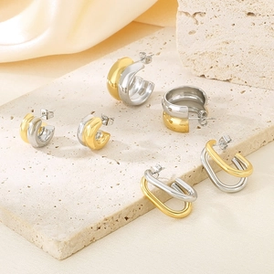 Boucles d'oreilles chic bicolores en acier titane sur socle en pierre, dorées et argentées