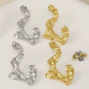 Macro detail of gold and silver irregular pleated 304 stainless steel stud earrings