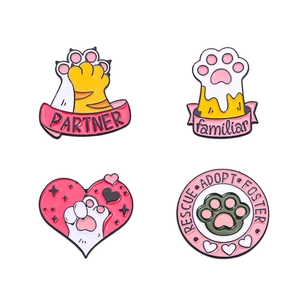 Set of four unique Halloween enamel pins featuring cat paws and rescue theme icons