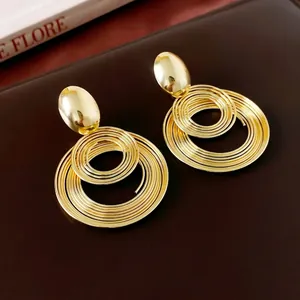 Exaggerated gold geometric spiral earrings with polished oval tops for women