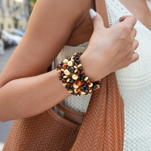 Multi-layer wooden beaded bracelet with earthy brown tones on model wrist